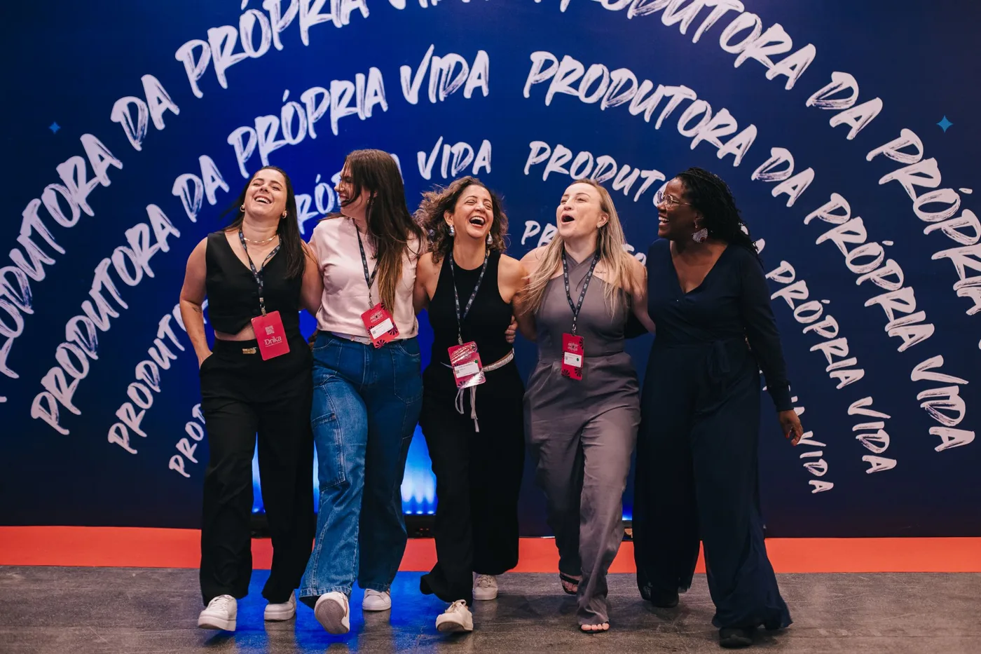 Participantes sorrindo em frente ao painel Produtora da própria vida